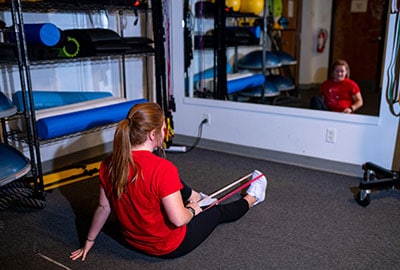 Student stretching in facility