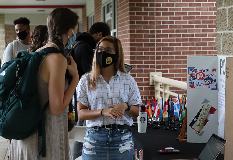 Student wearing a mask at a fair