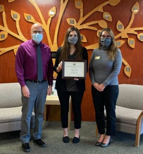 Davis & Elkins College sophomore Aliyah Plum, center, receives her certificate for completion of the West Virginia School of Osteopathic Medicine Green Coat Program.