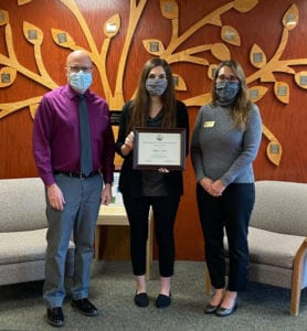 Davis & Elkins College sophomore Aliyah Plum, center, receives her certificate for completion of the West Virginia School of Osteopathic Medicine Green Coat Program. 