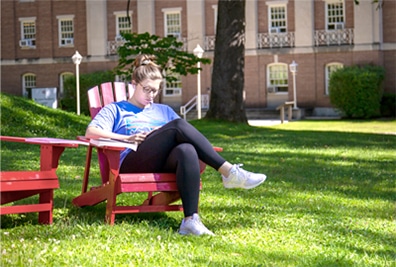 Girl studying in a chair outside