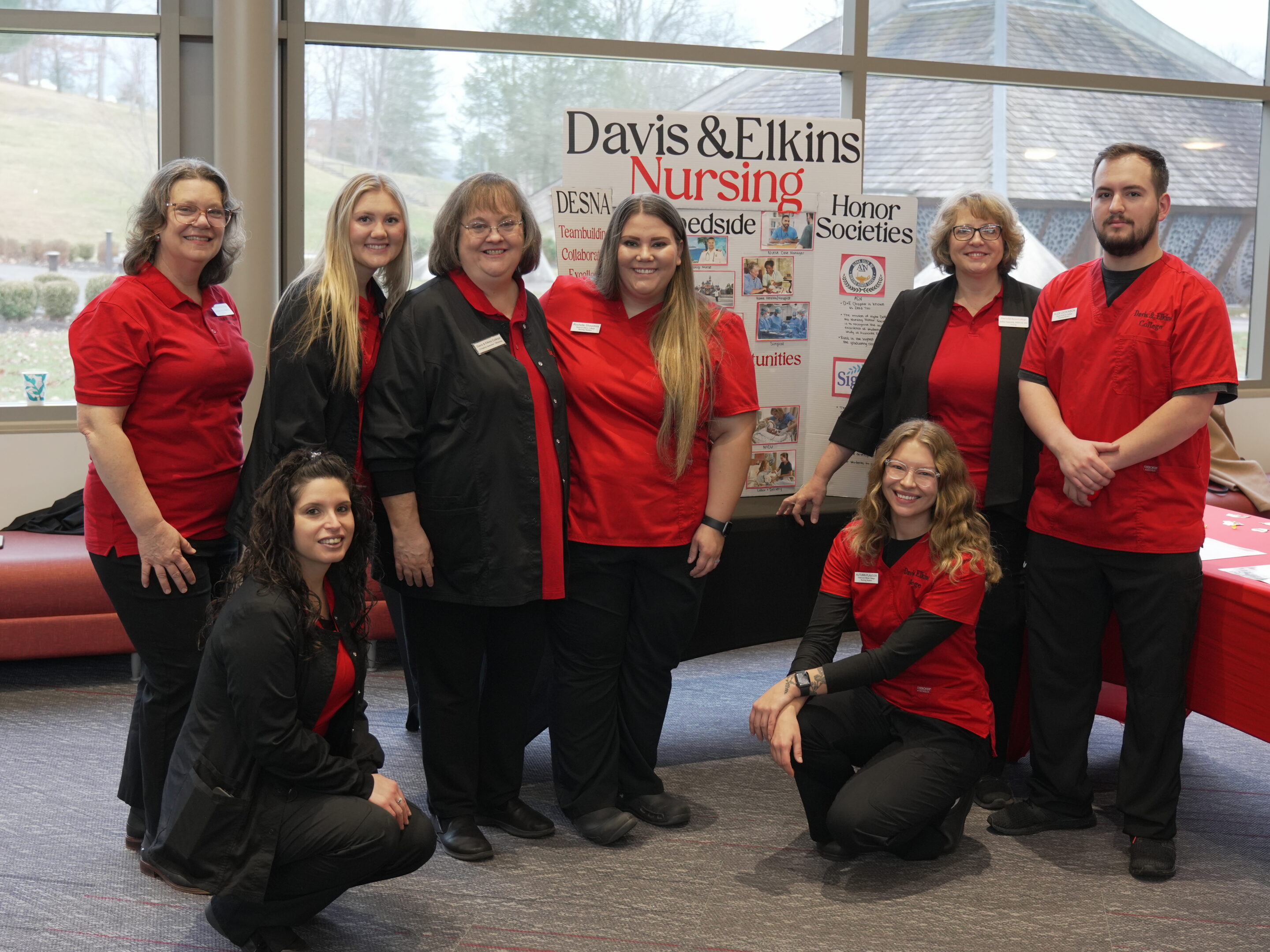 D&E nursing program faculty and students gathered in front of a sign at a recent open house
