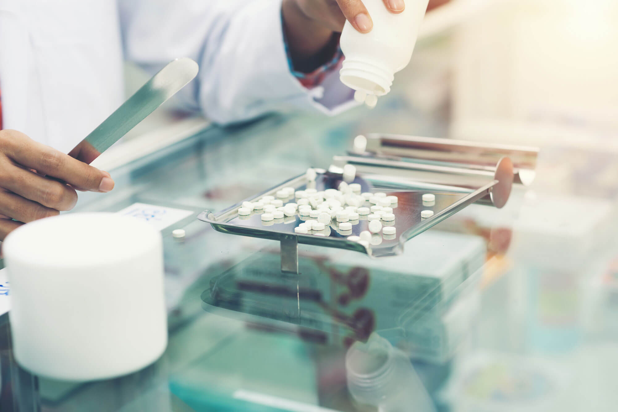Pharmacist counting pills